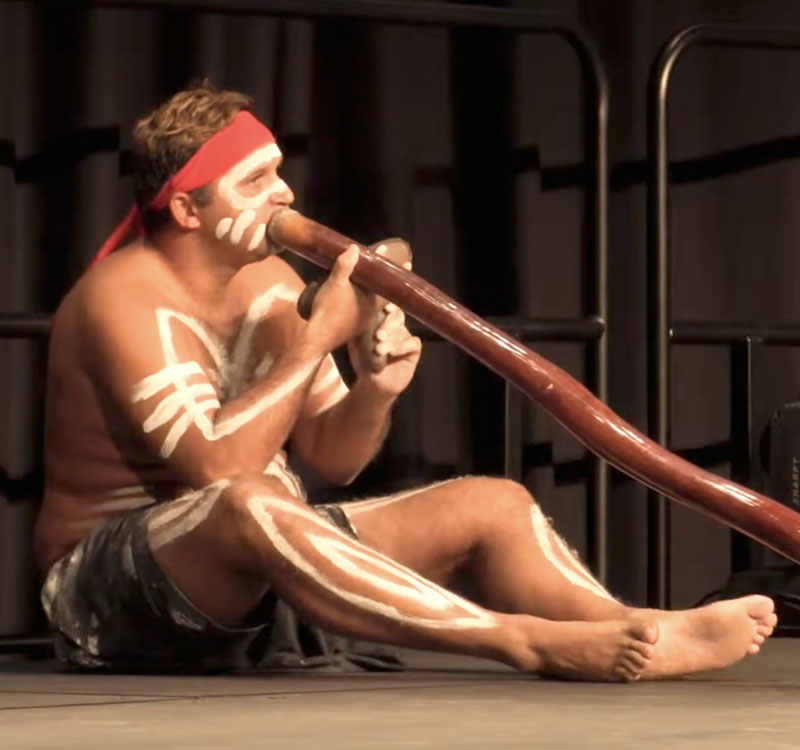Aboriginal act entertaining guests on a harbour cruise 